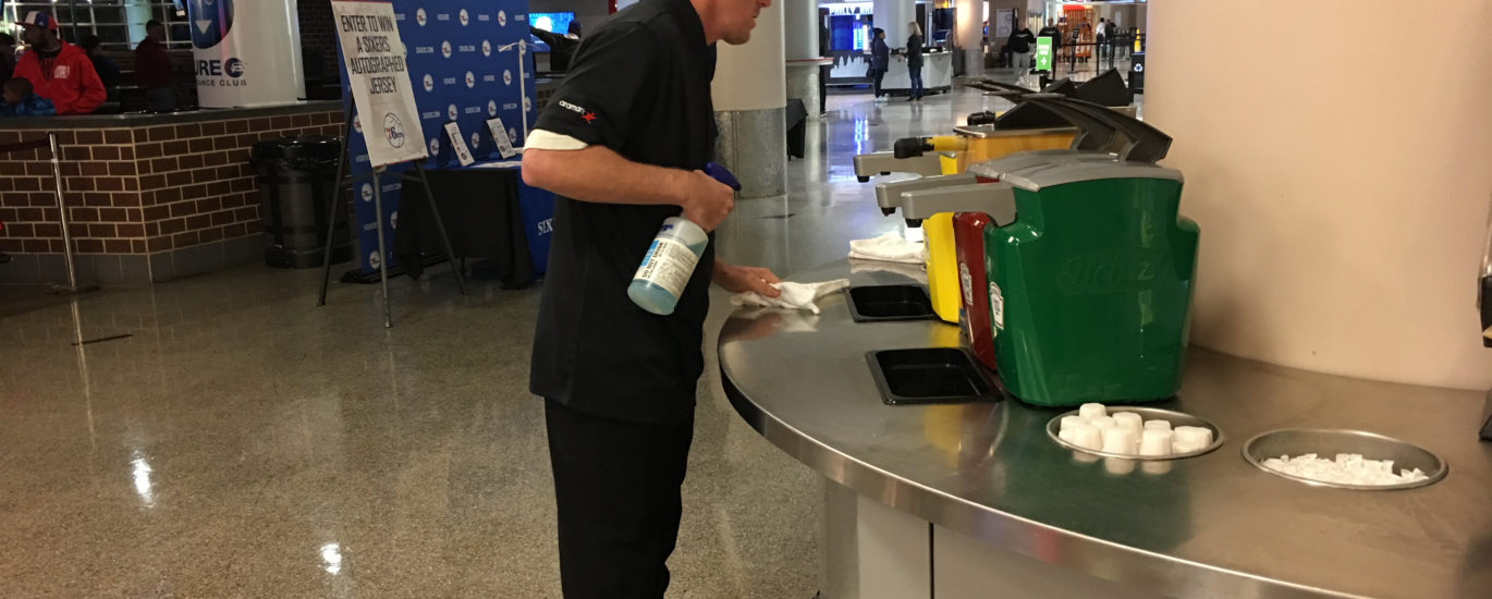 Concessions worker wiping counters